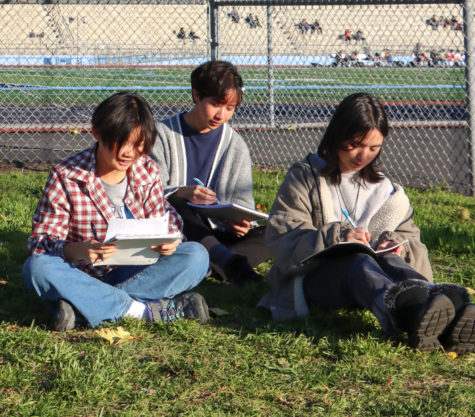 (From left to right) Freshman Alyx Chow, senior Erin Morales and sophomore Melinda Qerushi sit and write.