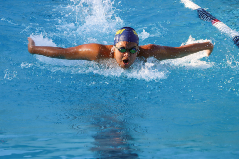 The final effort | Varsity boys captain sophomore Jaydan Trinh swims in the 100 yard butterfly. “It’s a really tiring
stroke but it’s one of my strongest ones; I placed second at this meet,” Trinh said. “I like swimming because when
I was younger I would always watch the swimming in the Olympics, which made me want to be like them. Even
though the practice is rigorous, it gives me a good workout.”