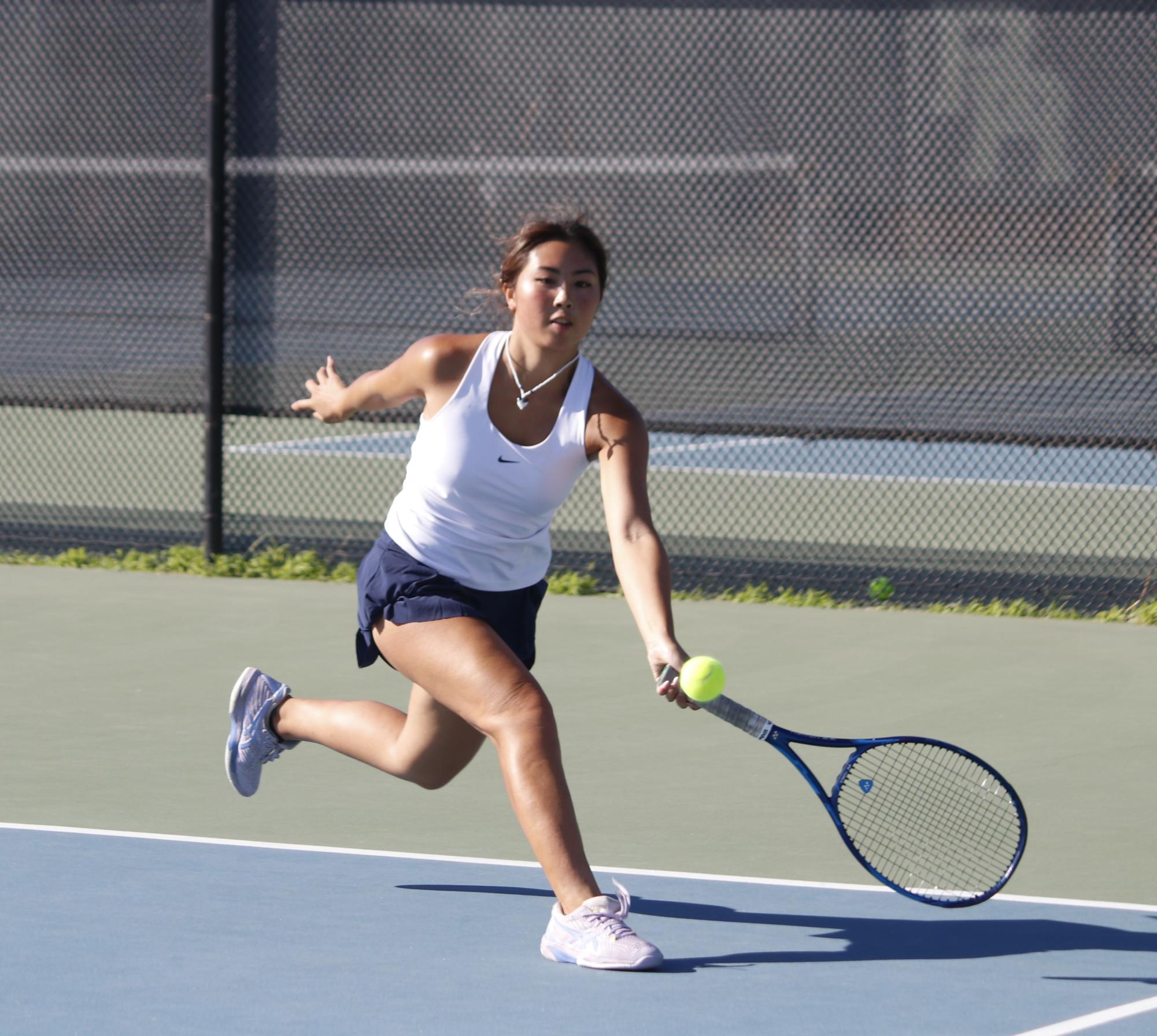 Singles 1 senior Kasandra Uy returns a shot from her opponent with a forehand. “I like putting away my volleys,” Uy said. “That’s just my way of getting points, but sometimes I also do a drop shot because it’s just fun.”