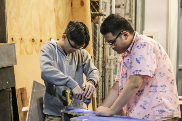 Stagecraft junior Kai-Yi Ho (right) builds stairs for the set with his partner stagecraft senior Ethan Chau. “[Stagecraft] is tiring most of the time, but the feeling you get when you finish a project is one that you can’t beat,” Ho said.
