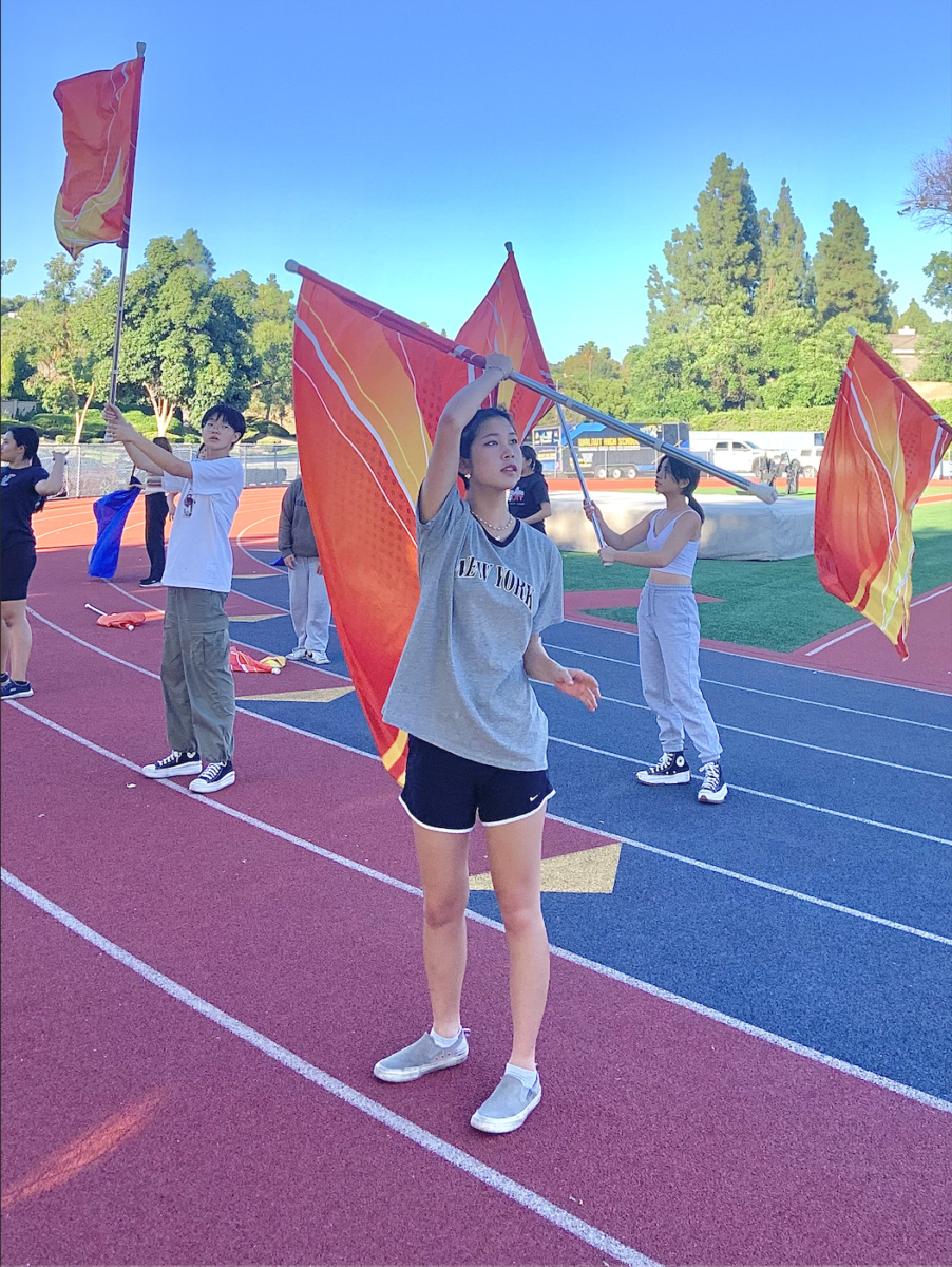 Junior Melody Wang practices a new choreography for upcoming performances with Color Guard. I feel excited to learn [because] it’s fun to [practice] for our show [using] the new choreography,” Wang said.
