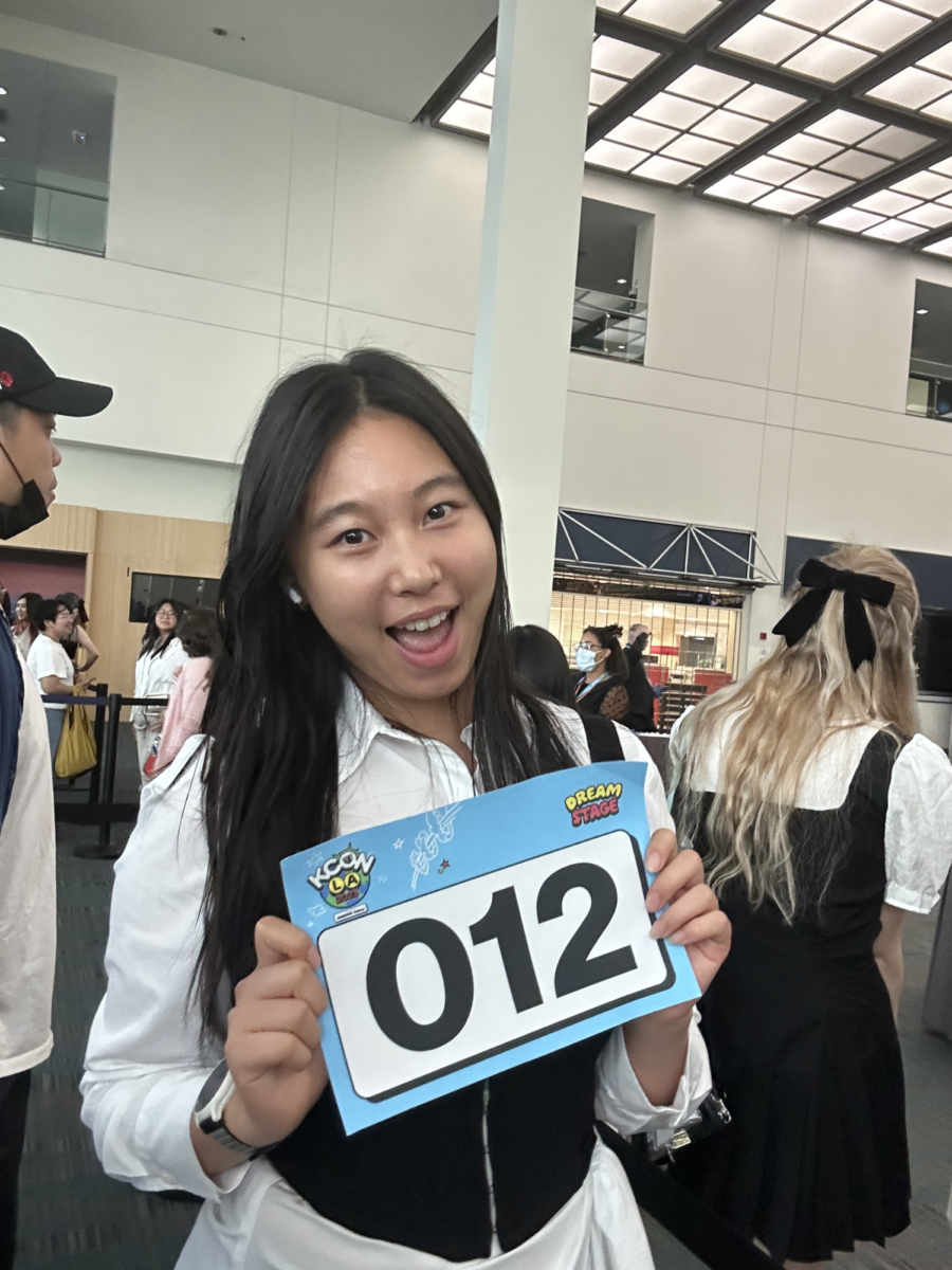 Junior Caroline Hong poses for a photo while holding her audition number. “I had the opportunity of being part of the audition process for the KCON DREAM STAGE and made it to the semi-finals out of thousands of applications,” Hong said. 
