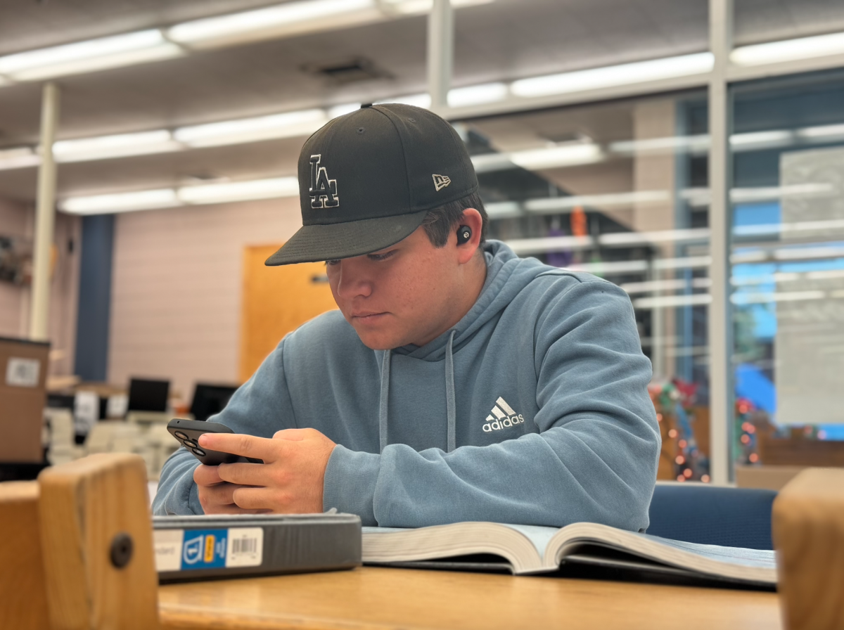 Catching up | Senior Matthew Velasco spends his free period at the school library to finish up homework and take some time to relax. “It’s just a good time to catch up on stuff in a nice and quiet environment,” Velasco said. 