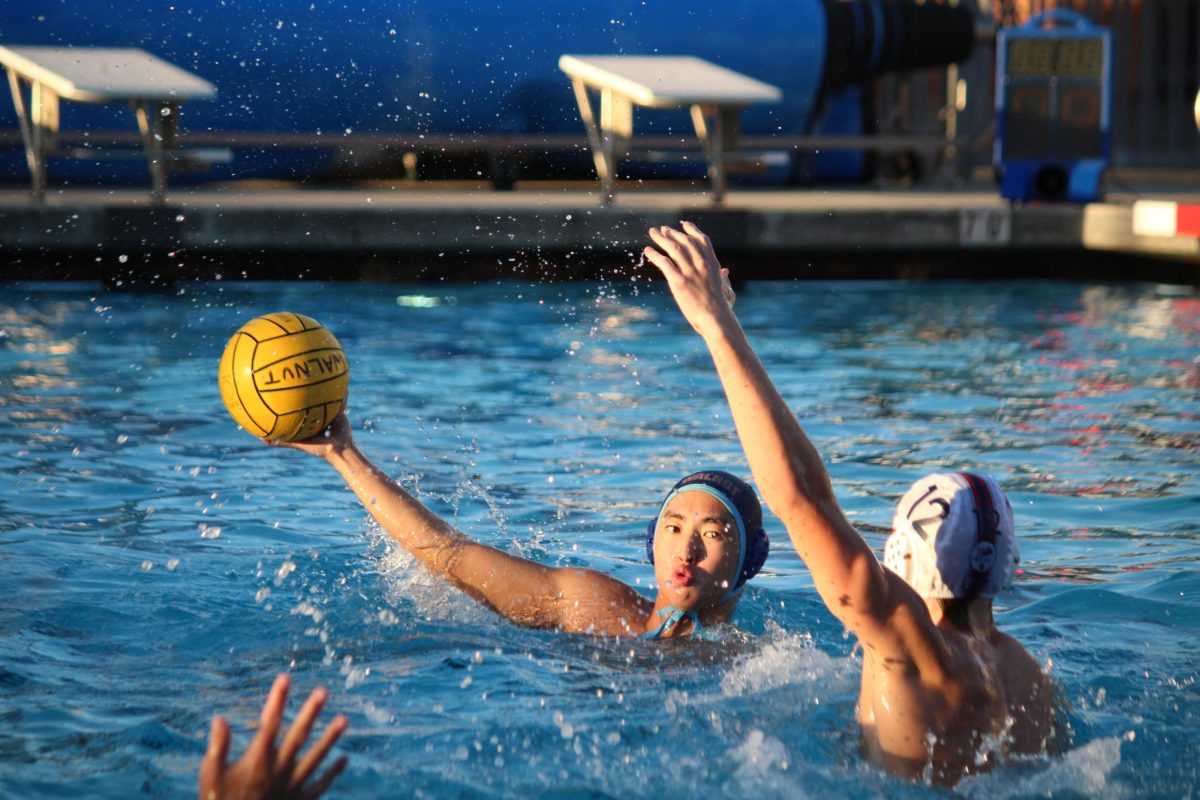 Sophomore Nathan Wang pumpfakes against the defender and goalie before shooting the ball in the cage. My performance during the game was okay, I felt like I did good on offense but I could improve on making my accuracy better, Wang said.  