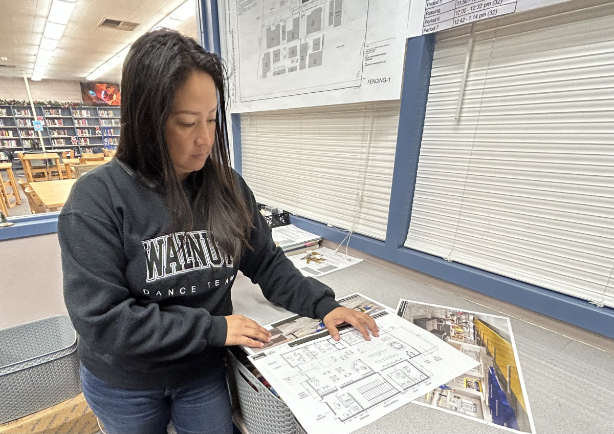 Operations manager Conchita Cawley evaluates blueprints for the renovated library. “ This is a great opportunity to get us up to date with technology and provide a better space for students and staff,” Cawley said. “It will create a safe spot for students to use and provide more opportunities for learning."