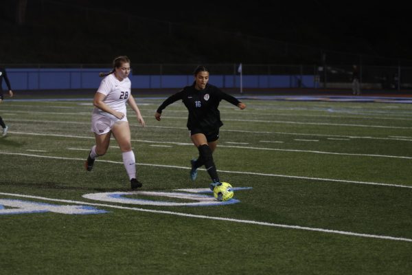 Center back junior Kailyn Ohara dribbles the ball up the field. 