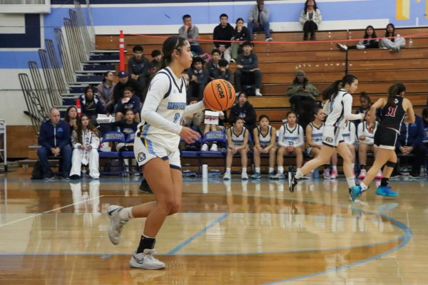 Center senior Maileeh Suasti gets her team into a half court set. “I felt a lot of adrenaline and pressure bringing the ball down the court because I knew the score was close and we had to come back,” Suasti said. 