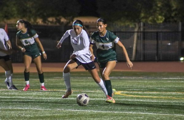 Forward freshman Ellie Lopez attempts to win the ball back from Los Altos. “Going into this game, my mindset was to win and try my best,” Lopez said. “In this moment my first thought was to be physical and win the ball.”