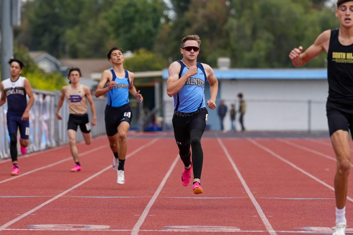 Senior Jacob Brawley begins to kick for the last 100 meters of his 400 meter dash. "My mentallity was focused on getting to CIF and everything was burning, which made me feel excited with my race so far," Brawley said. 