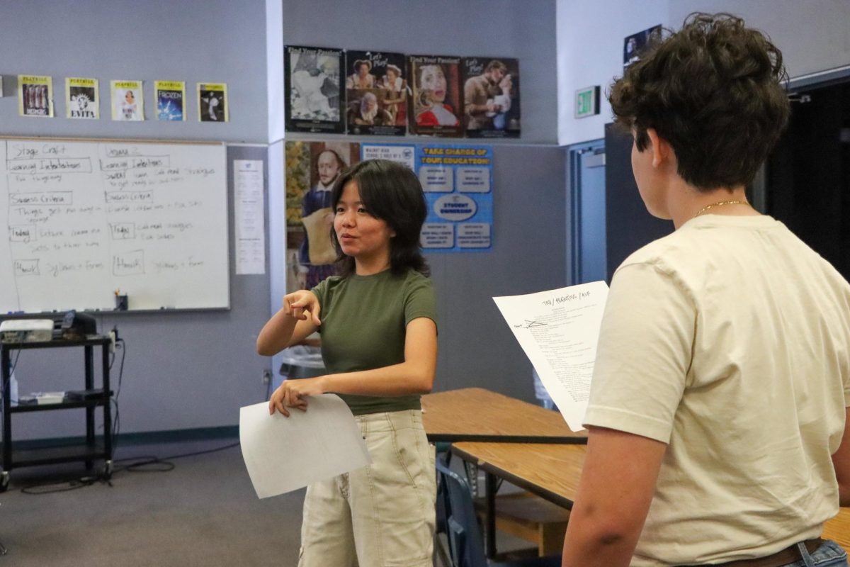 Sophomore Hannah Phan (left) and freshman Tobias Silva-Jameson (right) warm up for the "Peter and the Starcatcher" auditions. 