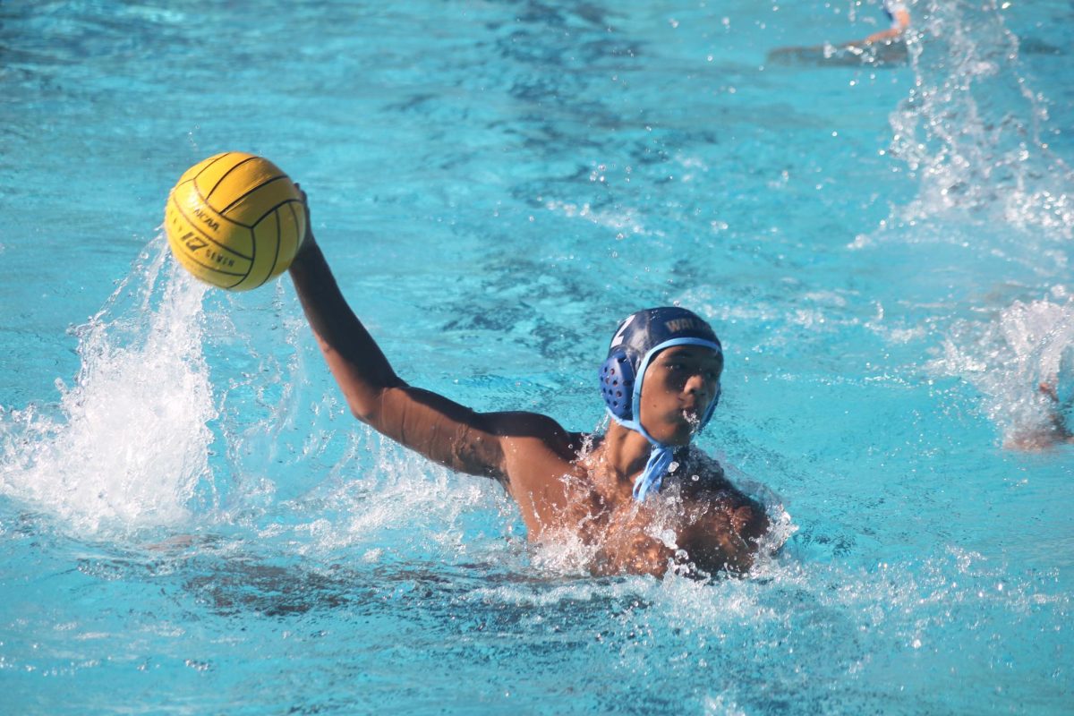 Preparing to launch | 4/5 attacker junior Anthony Santos winds up to throw the ball in the goal during their first league game against Claremont. “I needed to score as many points as I could, and I really wanted to win with my determination. 