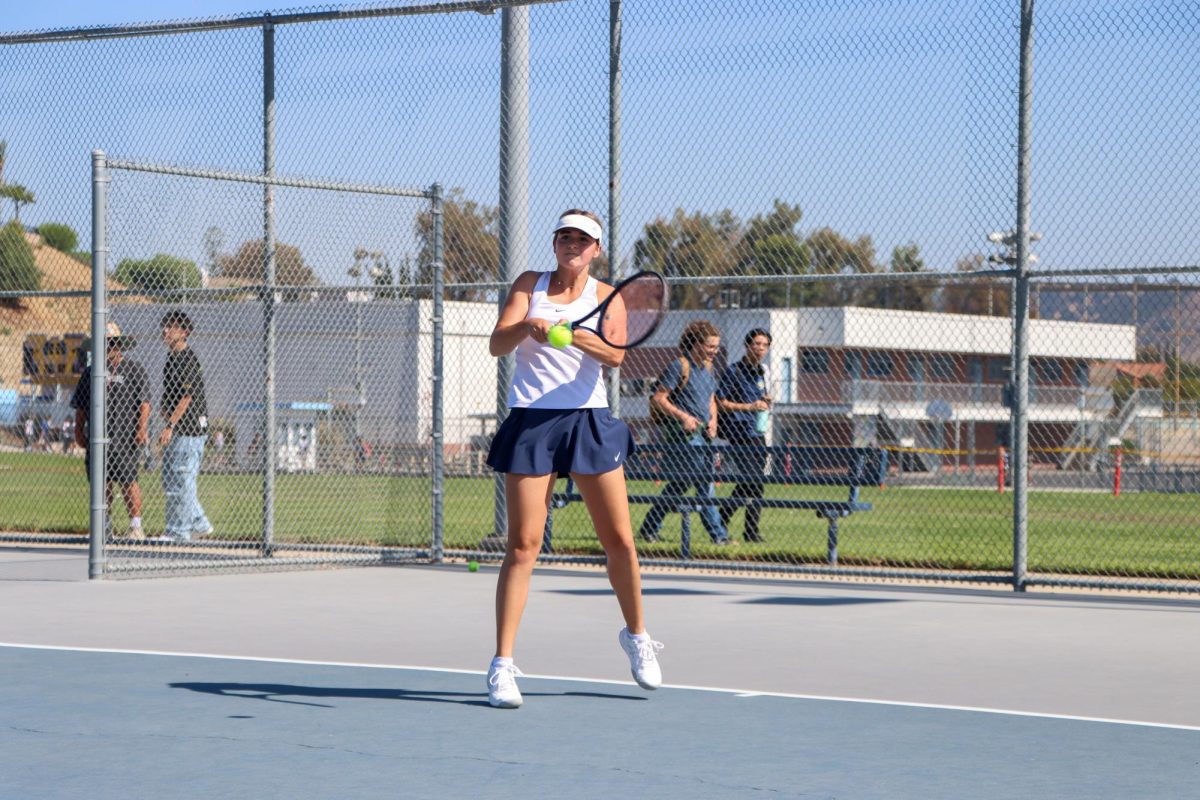 Senior Olivia Bromberg hits a backhand shot during a rally. 