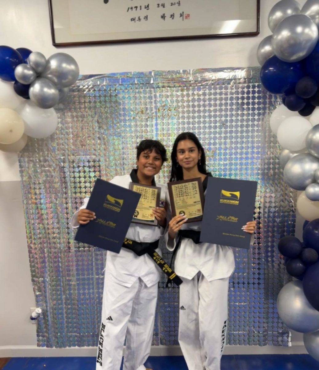 Sophomore Megha Bembi (right) receives an accolade for her achievements in taekwondo. 