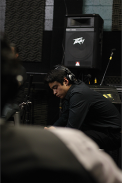 Junior Anthony Pabon listens back to a song in the studio. 