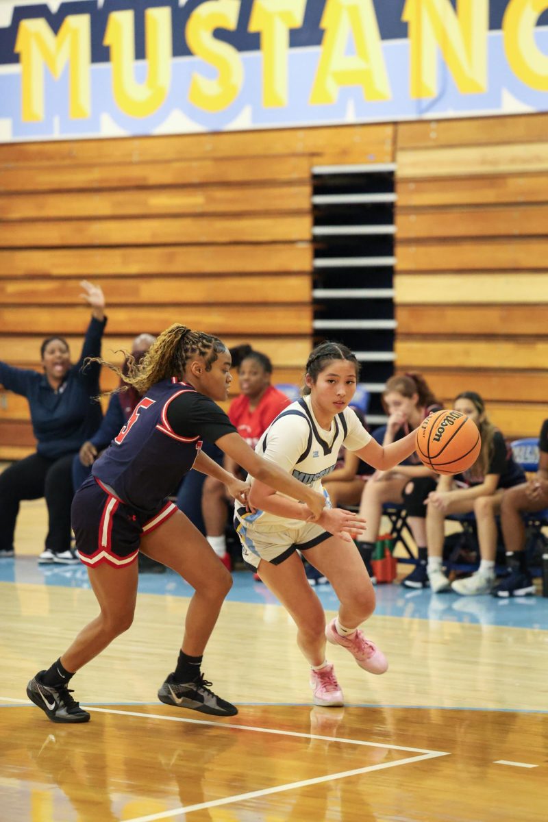 Dribbling to the key | Small forward senior Madison Shih drives toward the basket. “I saw an opening, and I wanted to help my team score.” 