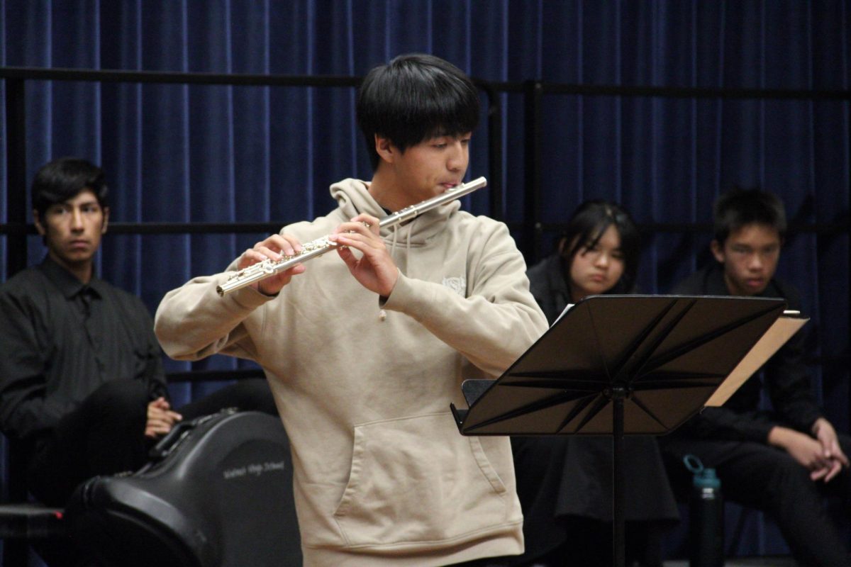 Freshman orchestra member Andrew Chen plays his flute during a master class at Cal Baptist University.