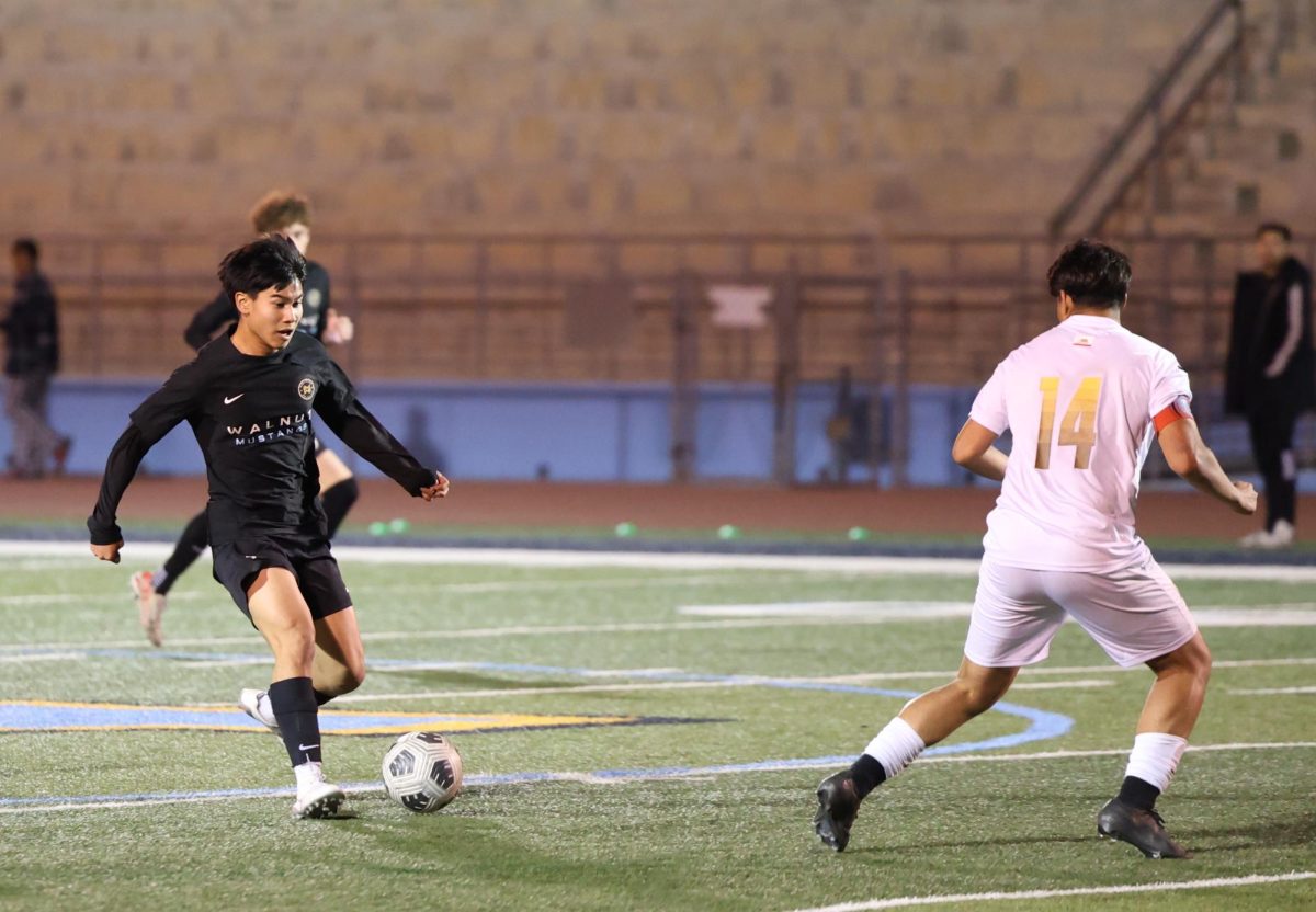 Playing offense | Right wing senior Sharl Gonzalez attempts to pass the ball to his teammate, striker senior Oscar Feria (not pictured). “I trusted [Oscar] enough to pass him the ball, so I felt like if I got him the ball he would have been okay, and it would have helped the team,” Gonzalez said. “I felt disappointed in the result of the game, but I feel like as a team we tried our best.”