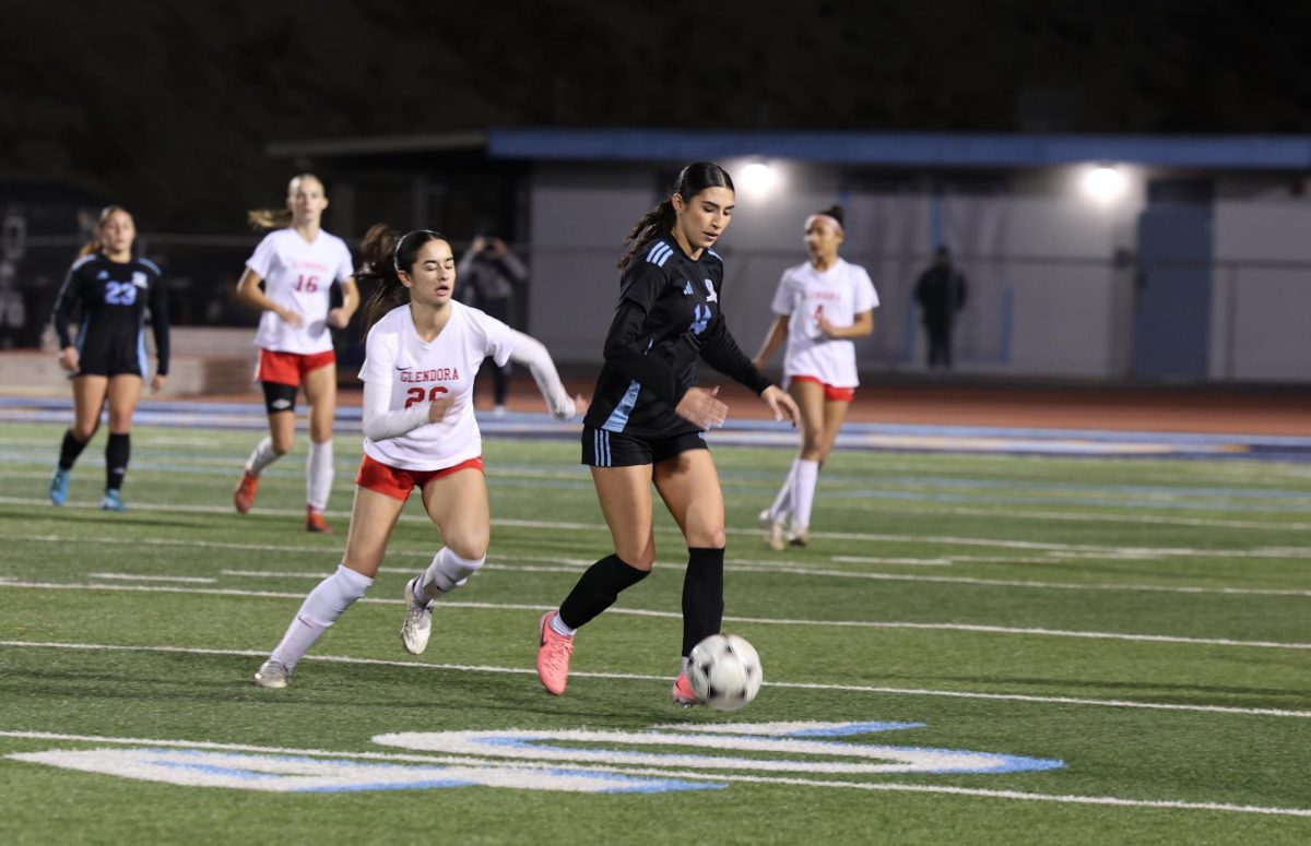 Junior Graciella Baird dribbles the ball up the field.