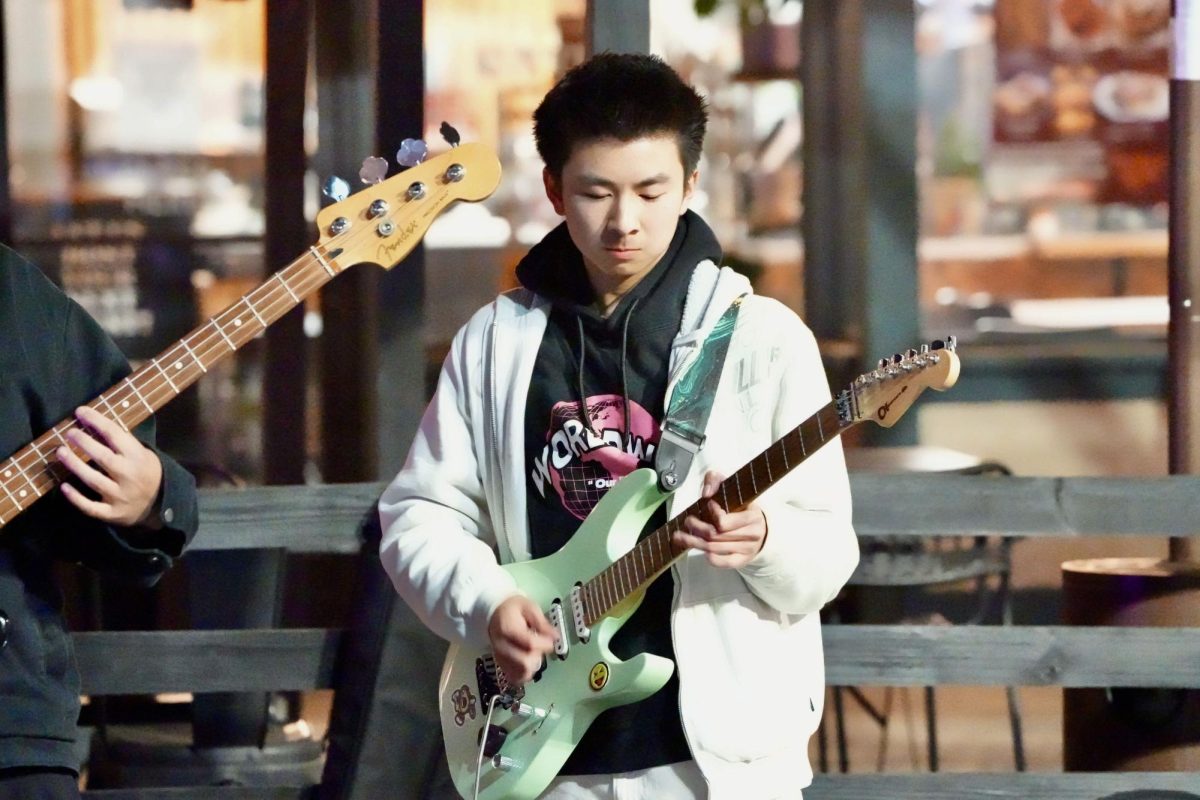 Music for miles | Sophomore Miles Nguyen plays electric guitar for a performance at Tiendaan Night Market in West Covina. 