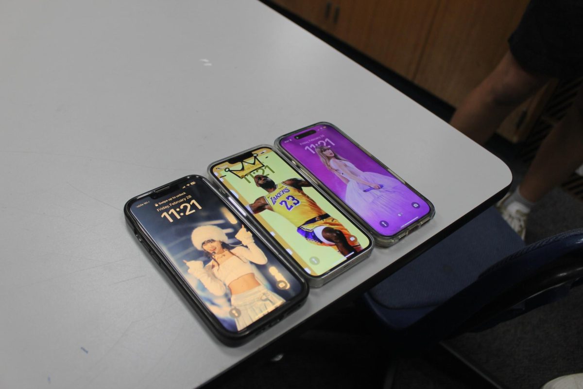 Three phones with the wallpaper of their favorite celebrity