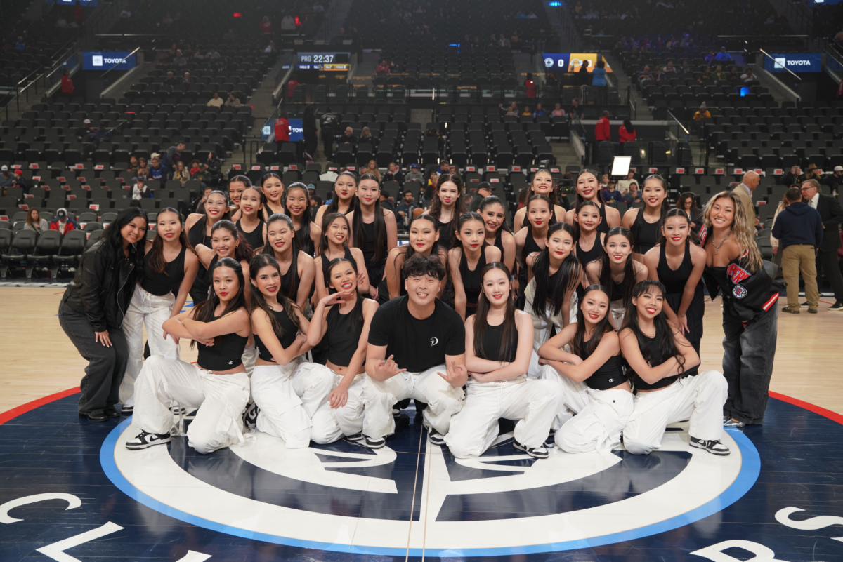 Freshmen Kaitlyn Shieh and Bethany Yu pose with the Dancecapade team at the Intuit Dome where they performed. 