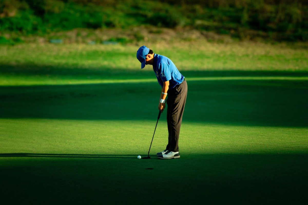 Sophomore Zachary Luo practices golf.