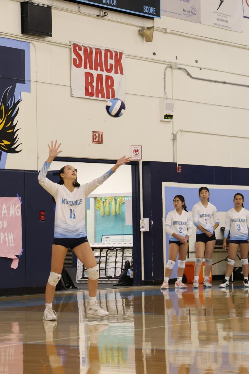 Middle sophomore Bernice Wen serves the ball. 