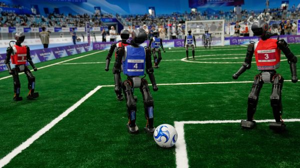 At China's World Humanoid Robot Games, several robots compete in a soccer match.  