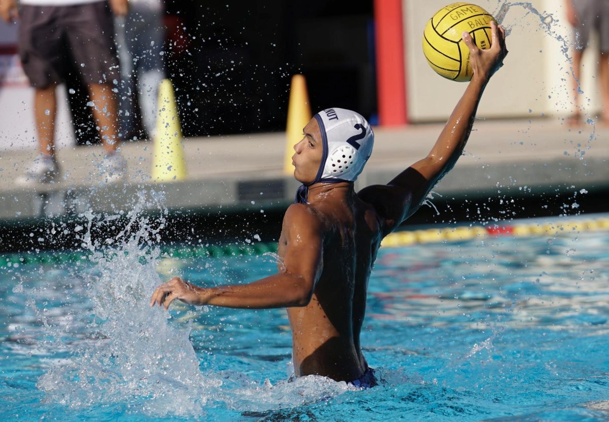 Captain senior Anthony Santos attempts to shoot the ball. "I was very happy about my performance during that game because even though we lost to them before, I stayed calm and collected being able to pick apart their defense," Santos said. 