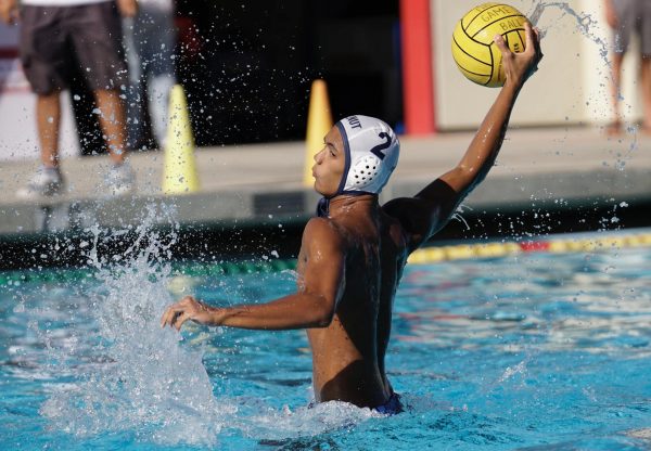 Captain senior Anthony Santos attempts to shoot the ball. "I was very happy about my performance during that game because even though we lost to them before, I stayed calm and collected being able to pick apart their defense," Santos said. 