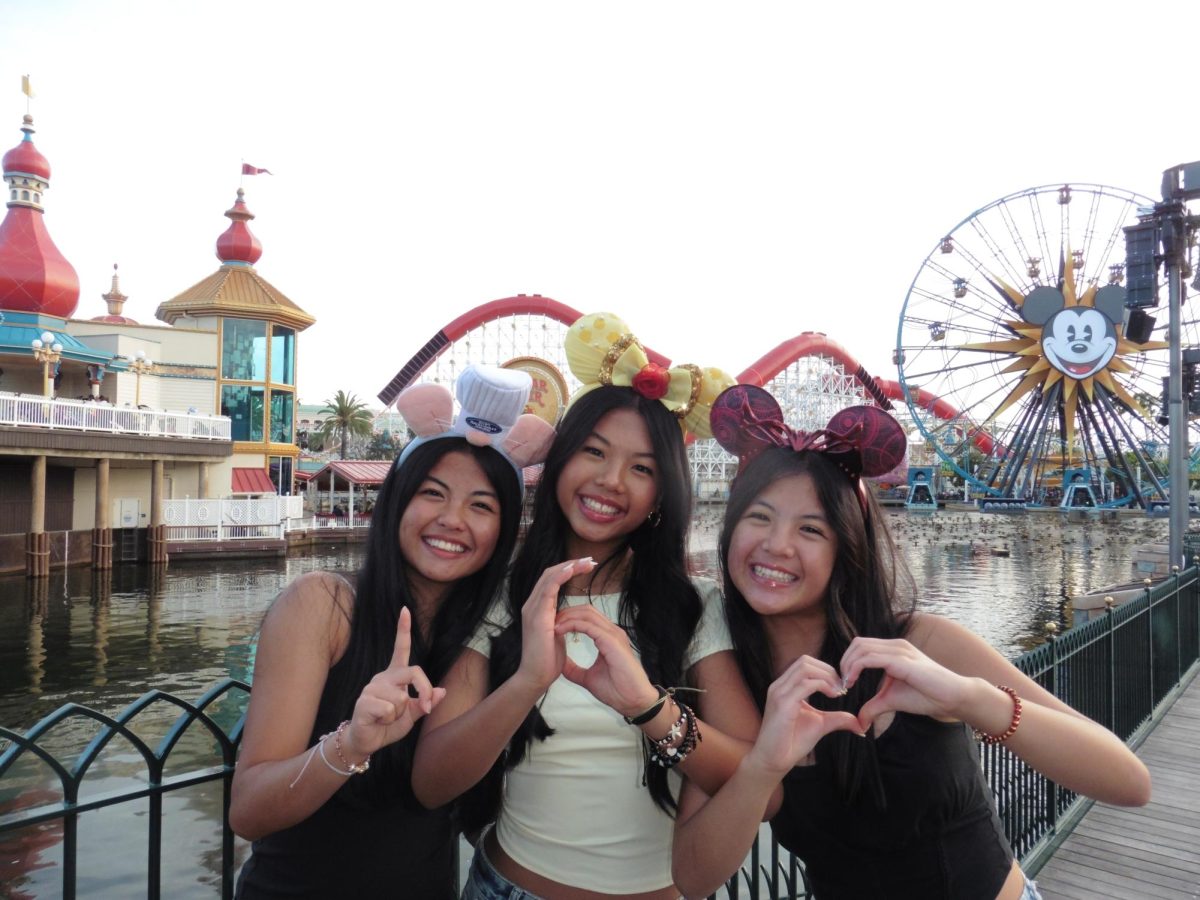 Triplets juniors Audrey, Lauren and Sarah Baybay celebrate their 16th birthday together at Disney California Adventure.