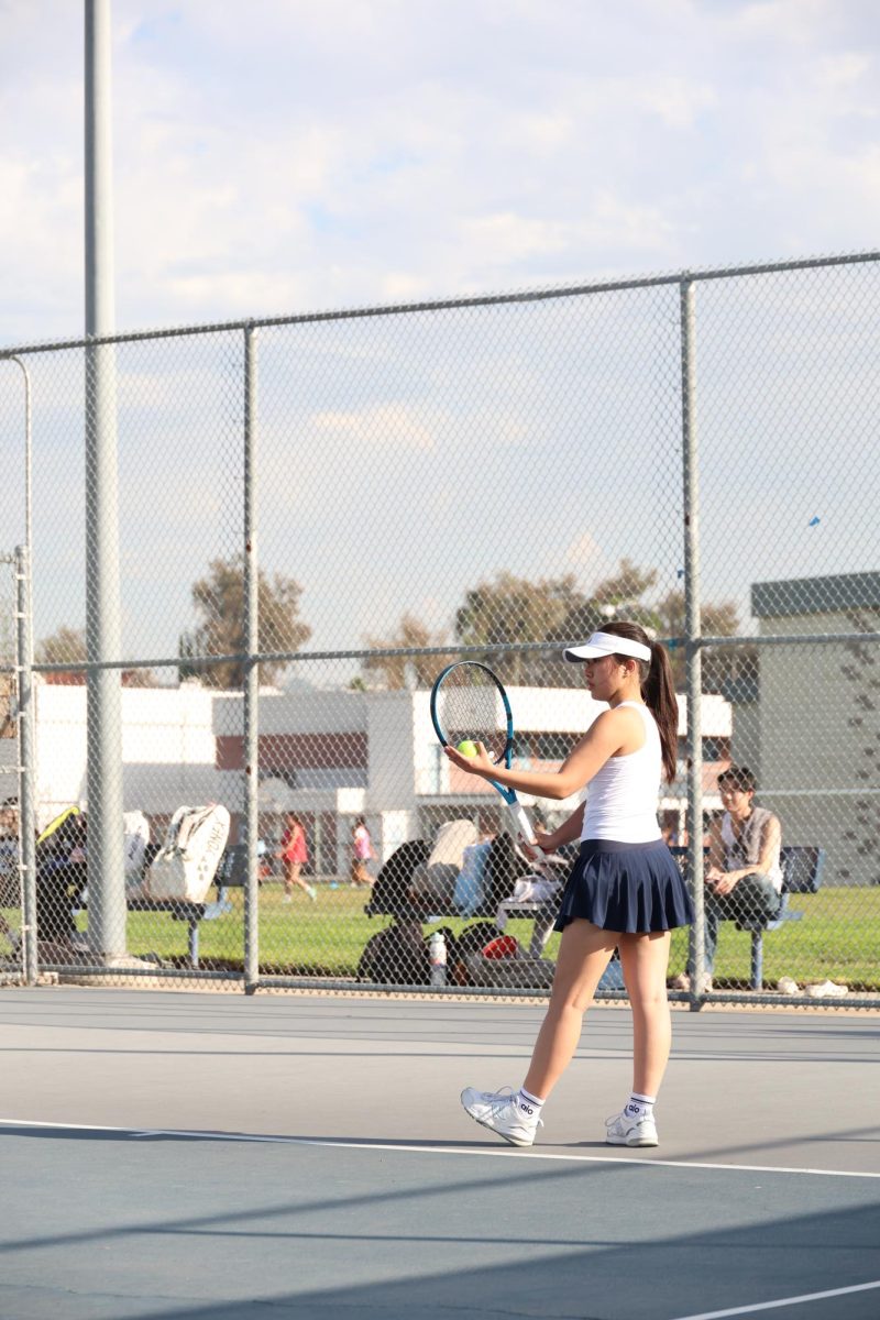 Serving the ball | Senior captain Sophy OuYang prepares to serve. “I feel like the team is a really big part of me,” Ouyang said.