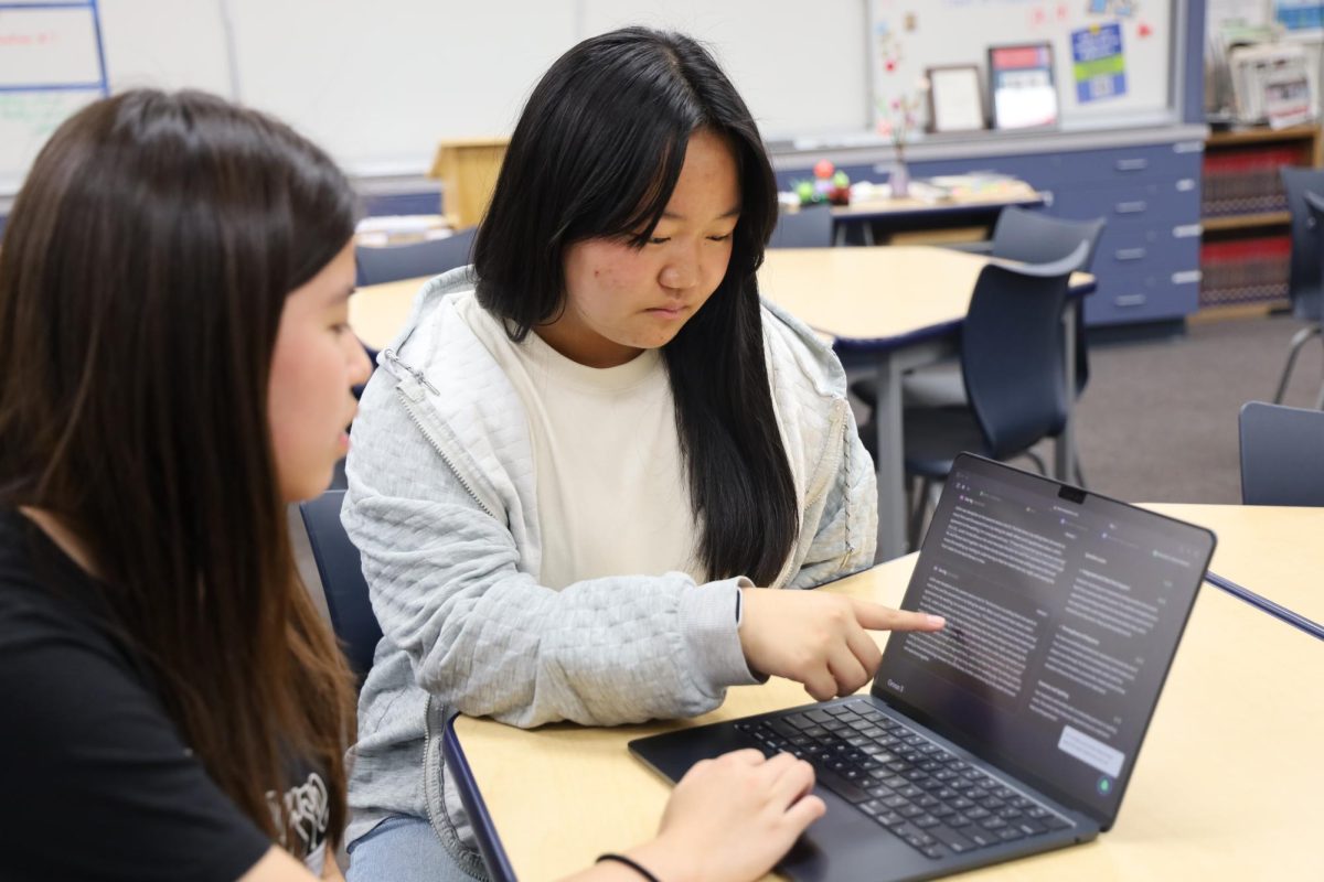 Completing the assignment | Sophomores Zoe Ng (left) and Ella Dong (right) use the AI software Class Companion to complete English assignments and receive AI-generated feedback. “The AI feedback given to me on my Class Companion assignment definitely helped me, because it was able to point out the mistakes that I might not have noticed as well as tell me what I did good, making me feel more confident in my answer,” Ng said.