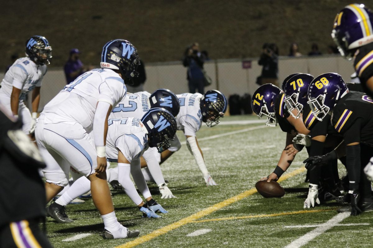 Walnut, who's on defense, lines up at the line of scrimmage during the game. 