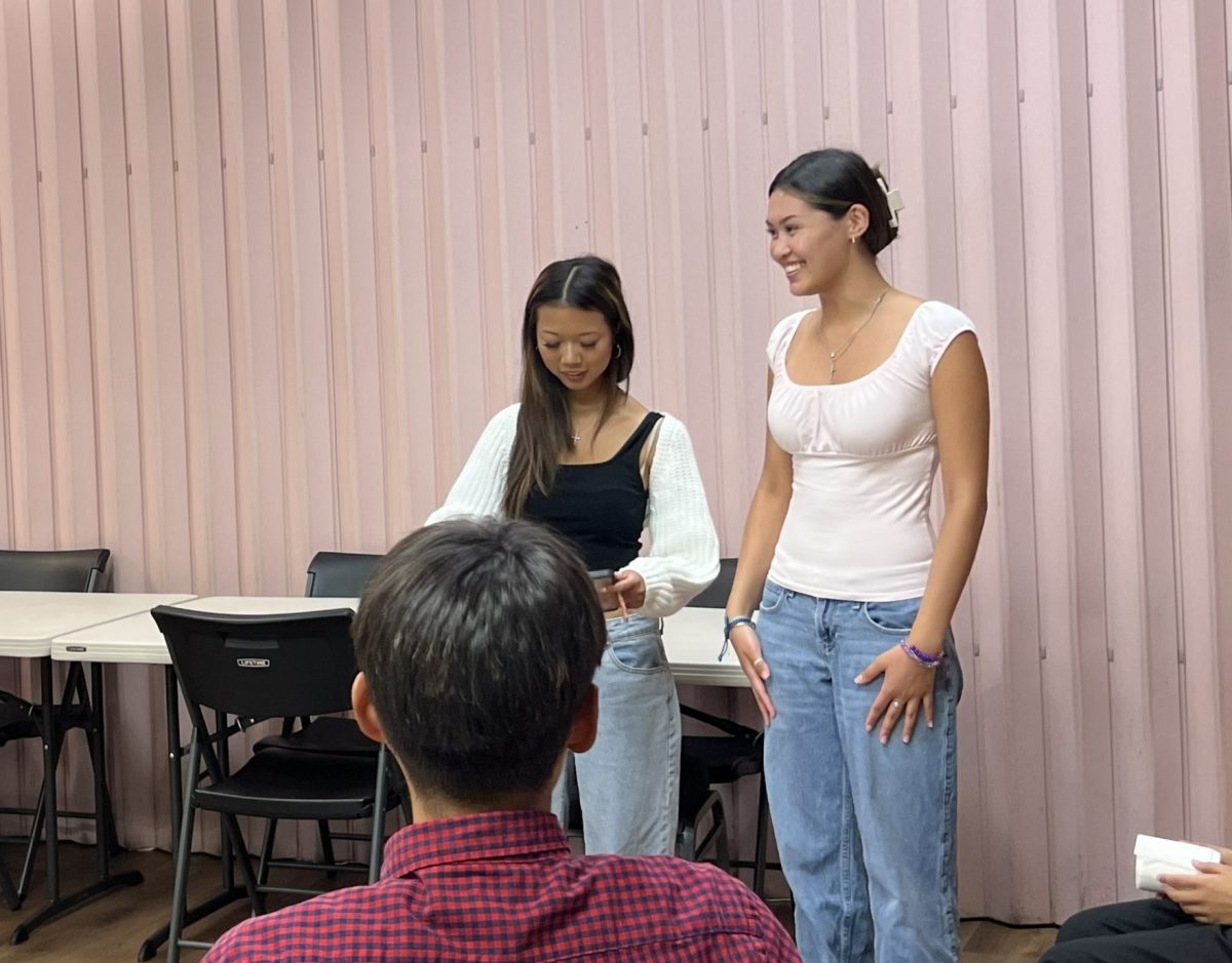 Seniors Emilyn Lopez and Paige Rivas engage participants in an activity during their weekly youth fellowship.