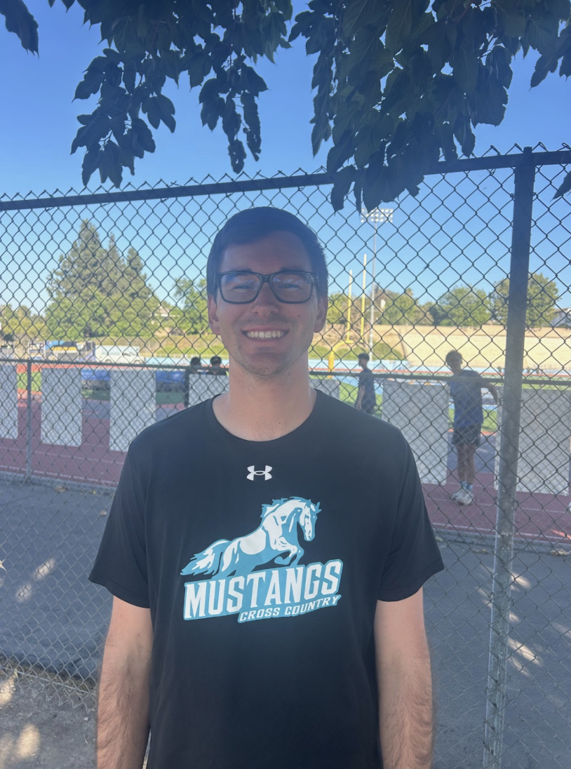 Head cross country coach Nathan Meier outside around the track. 