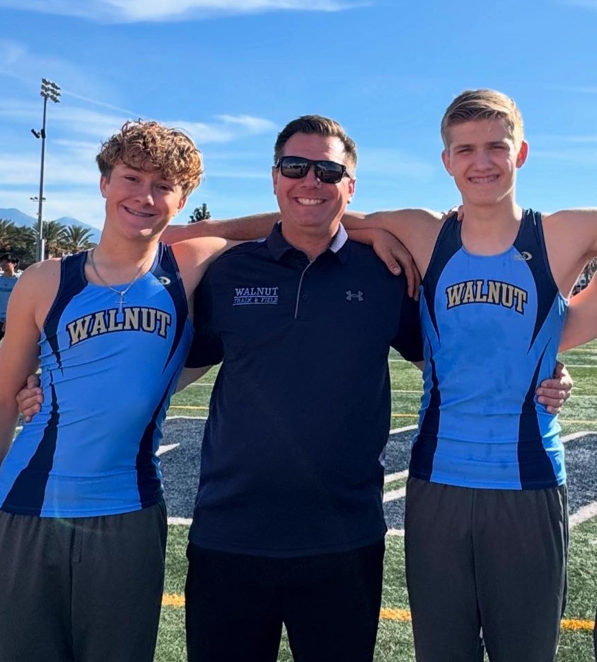 Back on track | Kinesiology teacher and head track and field coach Keith Thompson with his sons sophomore Jake and junior Ty Thompson at the Covina 5 Way meet. “I felt grateful for their support. My dad was across the field, but he came to watch me, which was nice,” Jake said.