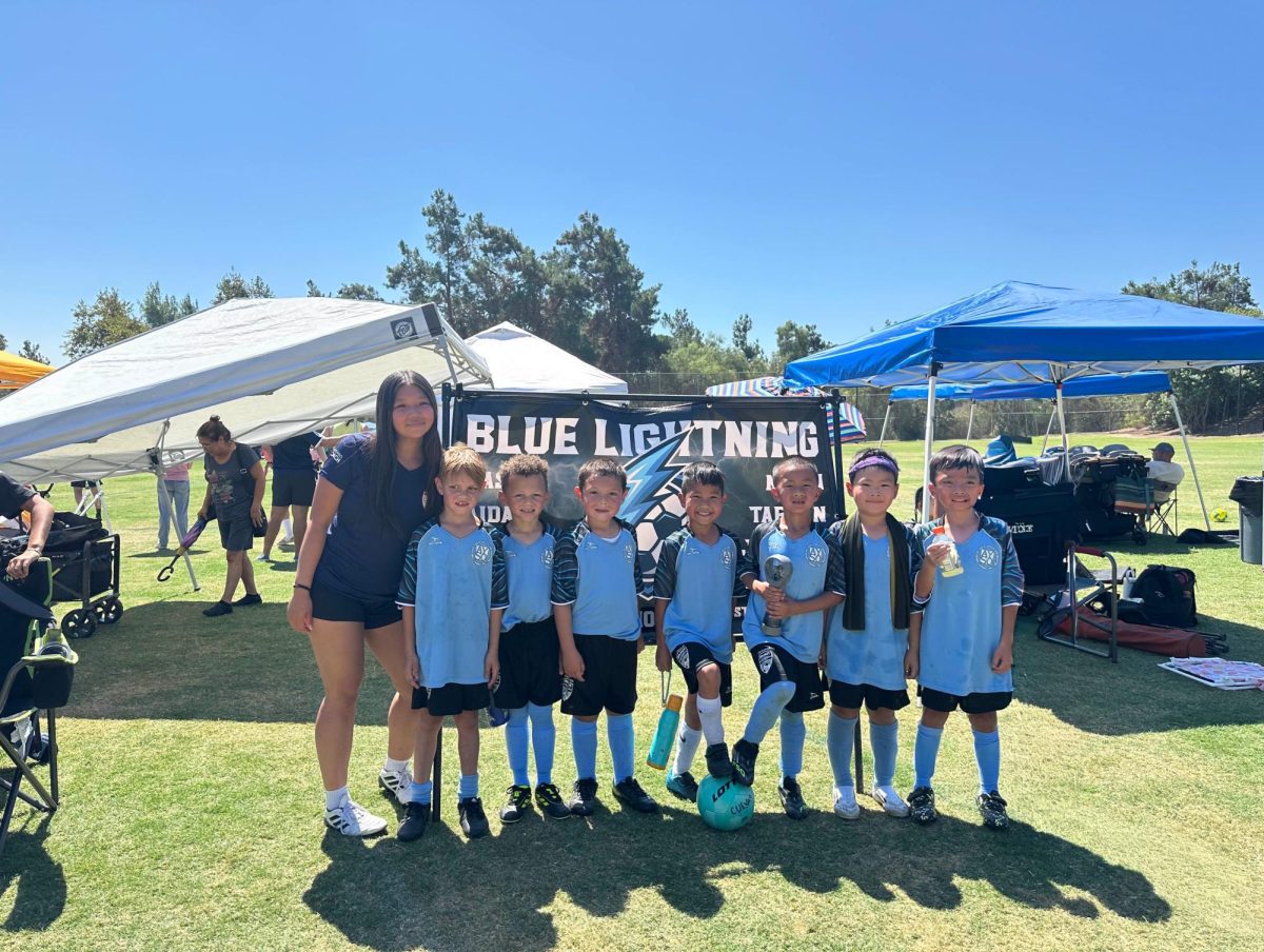 Cuan (left) poses with her AYSO team called "Blue Thunder."