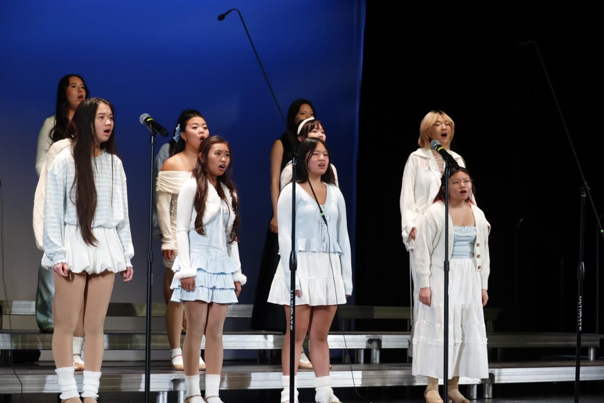 Christmas carols | From left to right, junior Myles De Los Reyes and sophomore Kirra Chin perform at Choir’s Winter Concert. “Even though the audience wasn’t that big [on Thursday], I think we still gave a good performance and gave good energy. I was really excited to perform really good songs,” De Los Reyes said. 