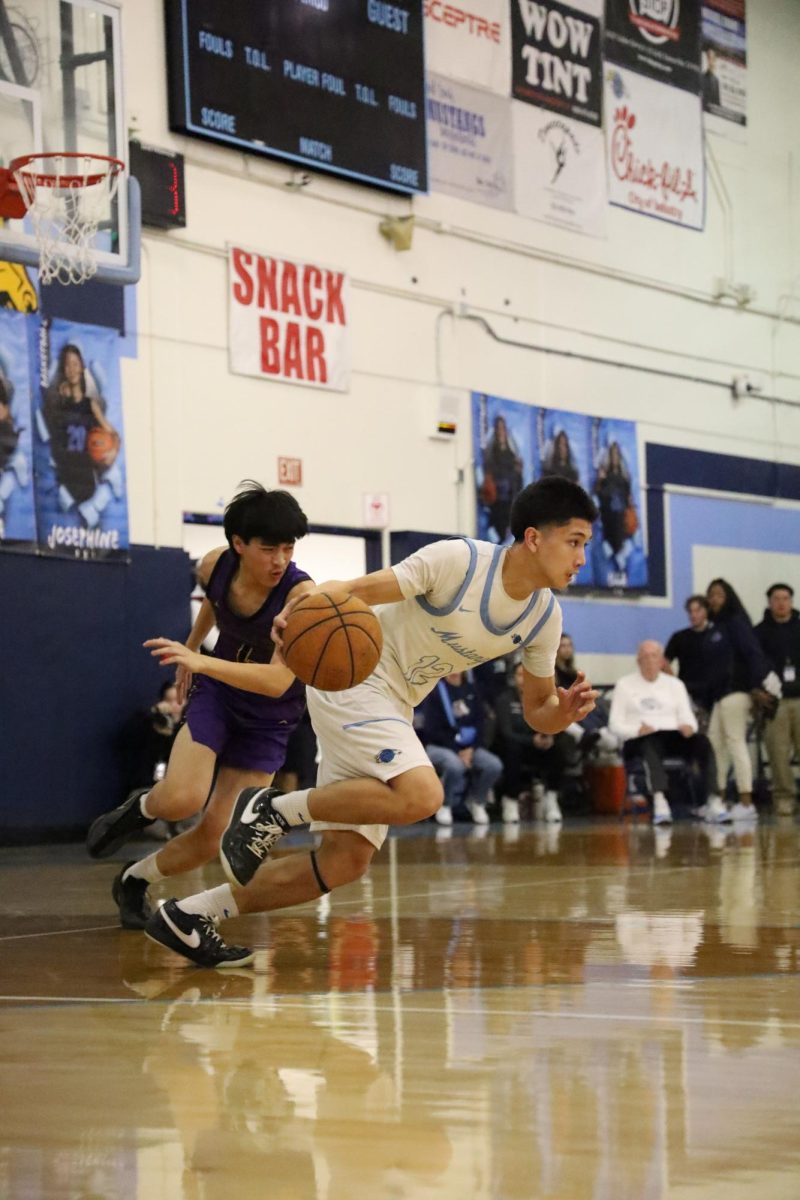 Shooting guard senior Jeremiah Vasquez advances the ball up the court. 