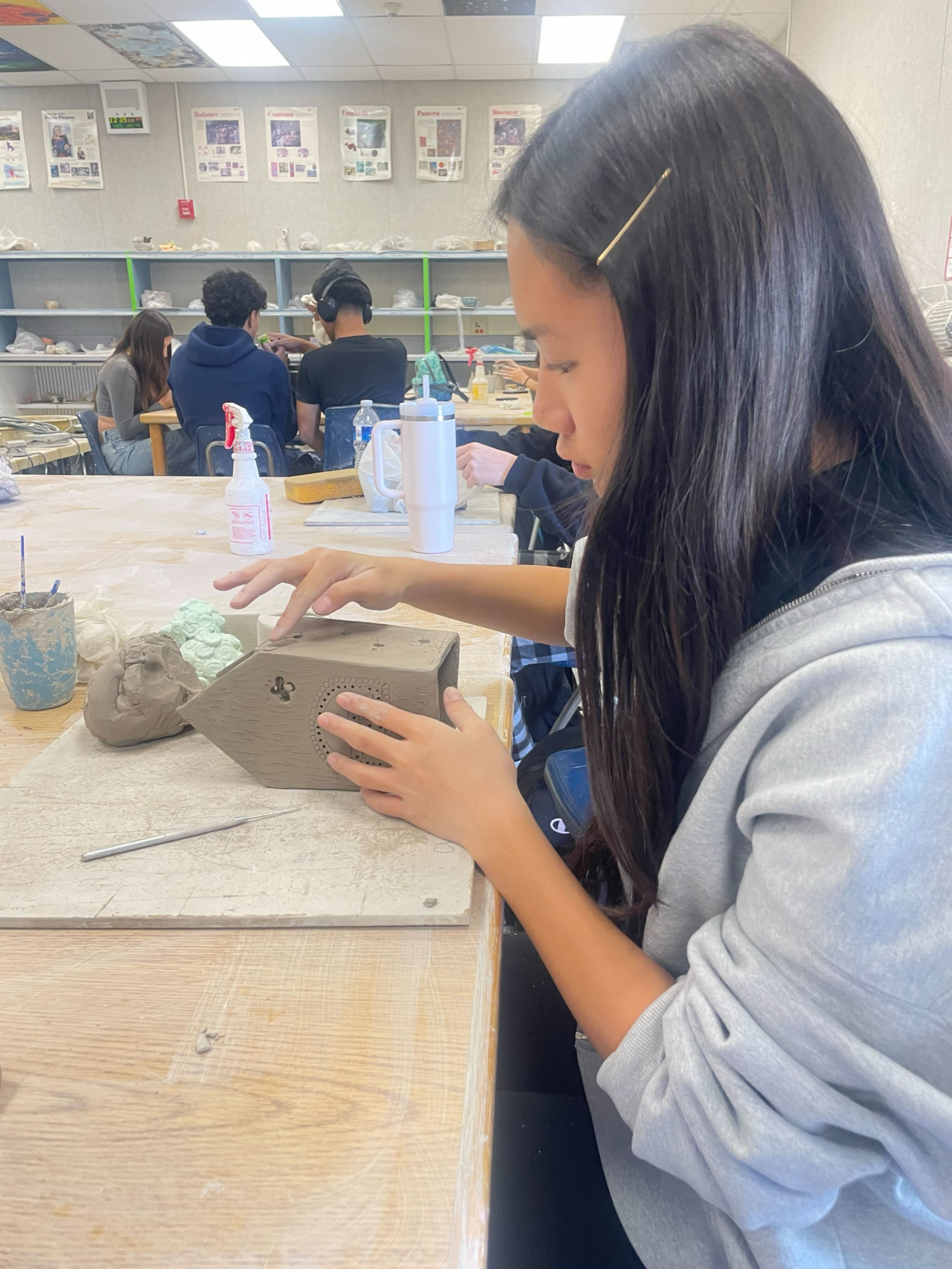 Shaping the mold | Intro to Ceramics student freshman Chloe Yick shapes one of her pieces. “I’m building a house that light can fit underneath so light can shine through it,” Yick said. 