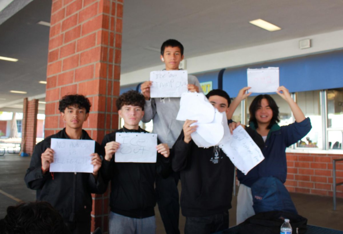 Voices raised | From left to right, junior Saer Malik, sophomore Jayden Felix,
freshman Fernando Herrera, sophomore Adan Campos and junior Alex Meng hold up handmade signs with slogans criticizing ICE at the ICE Walkout protest. “I walked out because I don’t want people supporting ICE and Trump, and I am okay with who I am and what my culture is,” Herrera said.