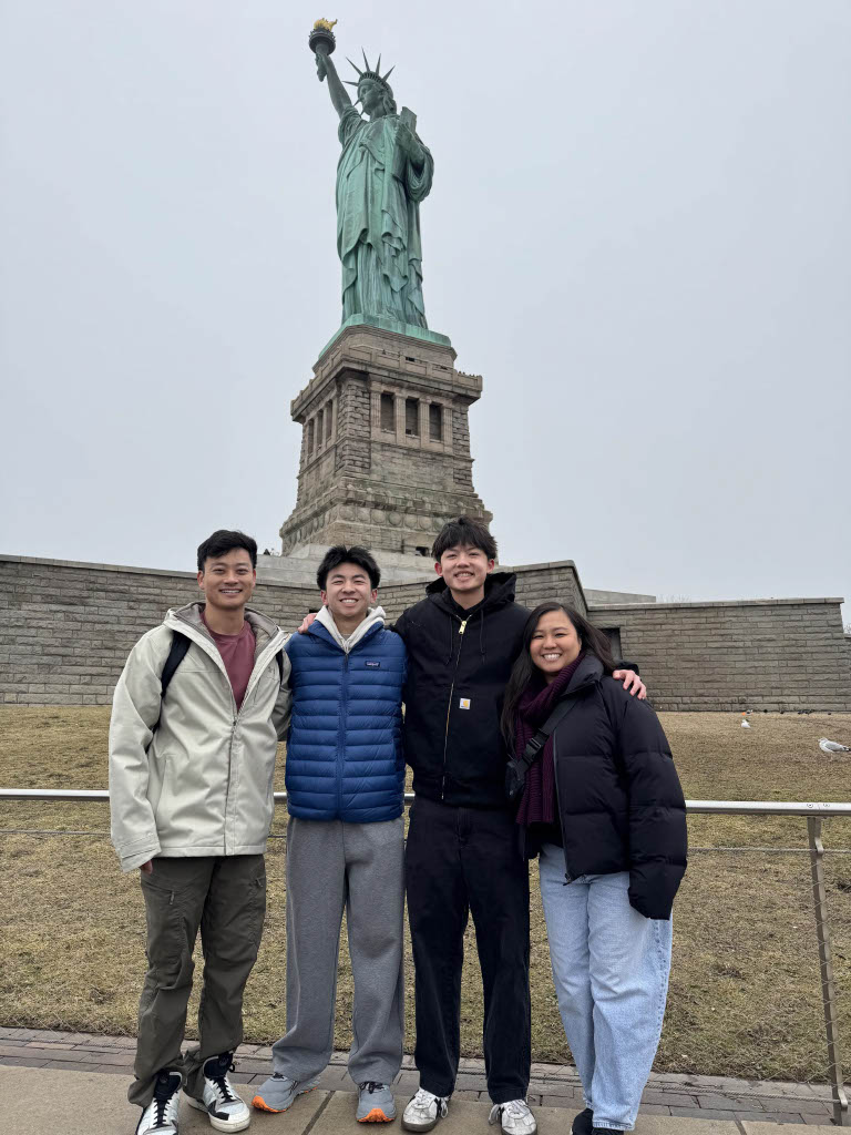 Visiting Lady Liberty | Drum majors junior Miles Nguyen and senior Keegan Beecher (middle) pose with instrumental music teacher Katie Takahashi. “Seeing it in person is cool because I can take in the magnitude of it. We also got to see the building process,” Nguyen said. (Photo courtesy of Miles Nguyen)
