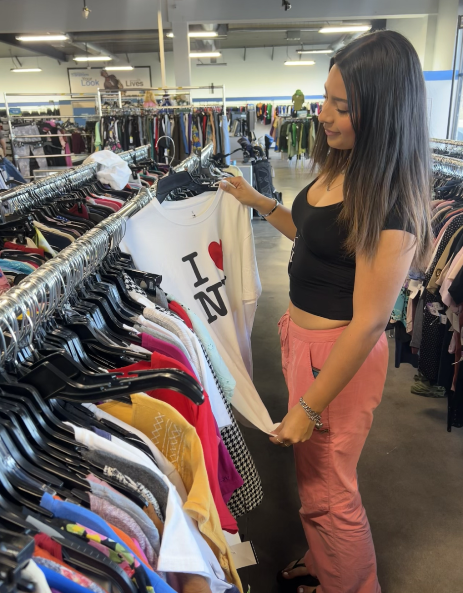 Thriving for the thrift | Junior Mia Martinez looks for clothing pieces at her local community thrift shop on Nogales St. in preparation for their nonprofit “Club Threaded.” Scouring bins to acquire clothing ready to wear is a challenge for the two, showing their passion towards the cause. (Photo courtesy of Mia Martinez)