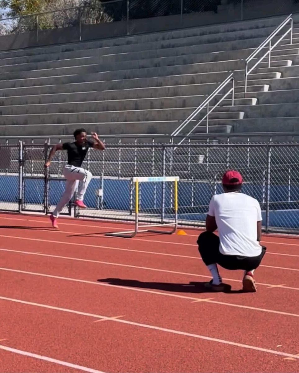 Coach Jasher Foster trains senior hurdler Brendan Neely to his fastest potential (Courtesy of Jordan Rios)