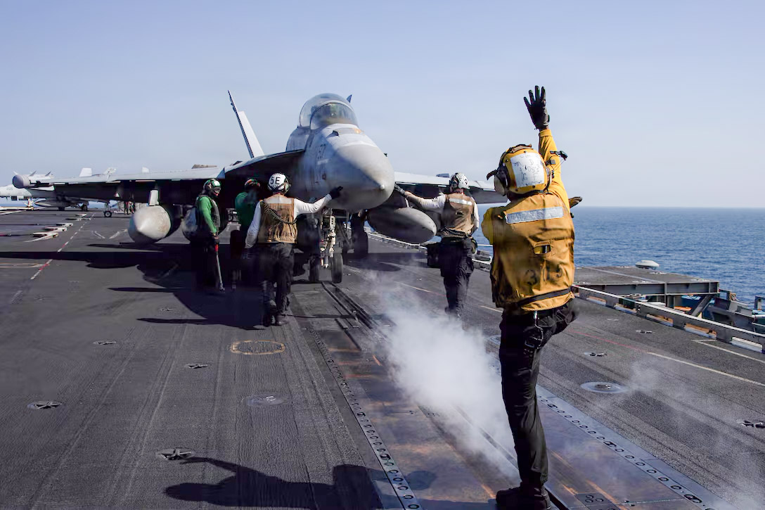 Launch Prep | With the commencement of Operation Epic Fury, the military operation that initiated the war, the warfare airplane EA-18G Growler prepares to launch from the deck of an aircraft carrier. (Picture Credit: Navy)
