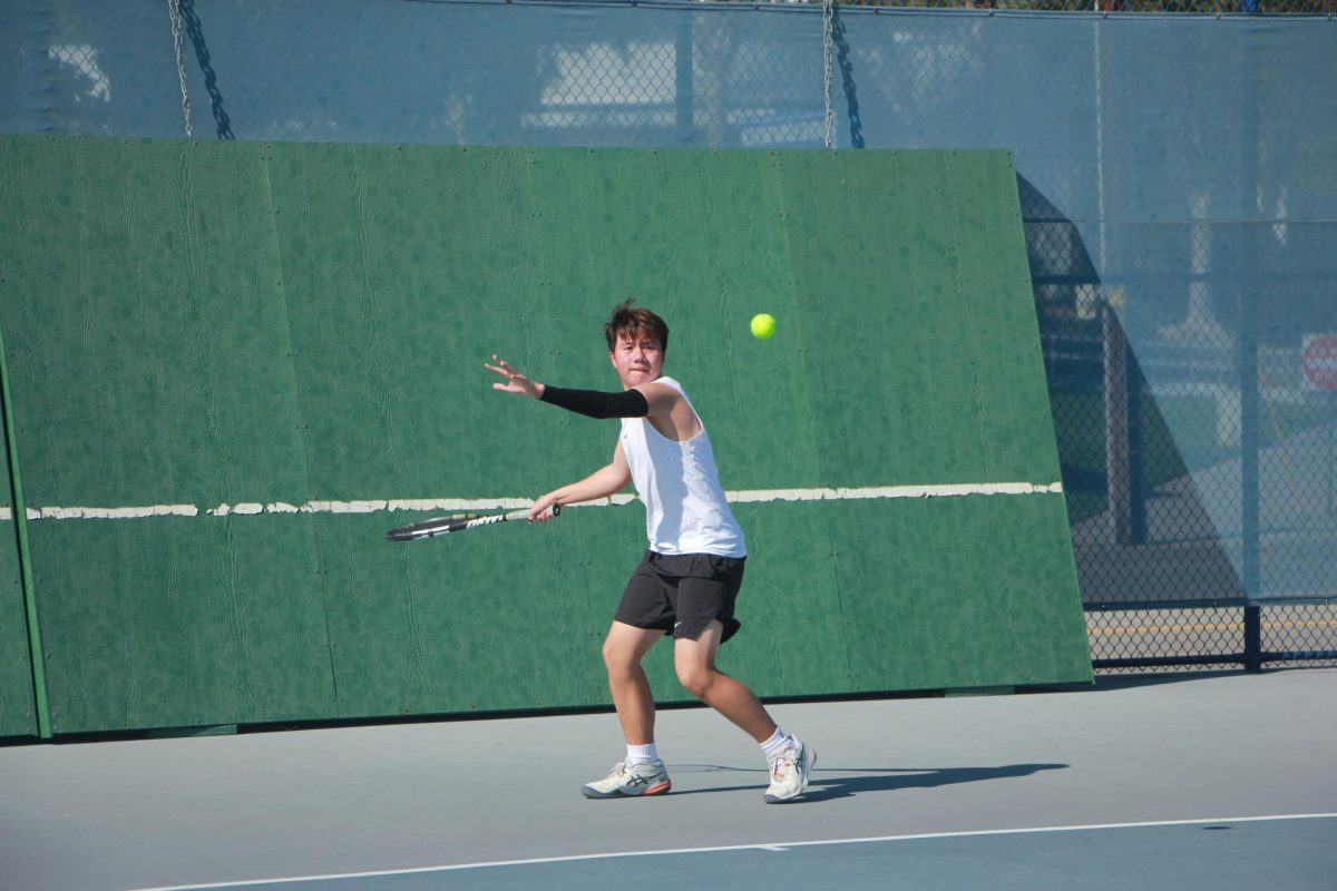 Singles three player Andrew Tanchoco swings toward the ball. 