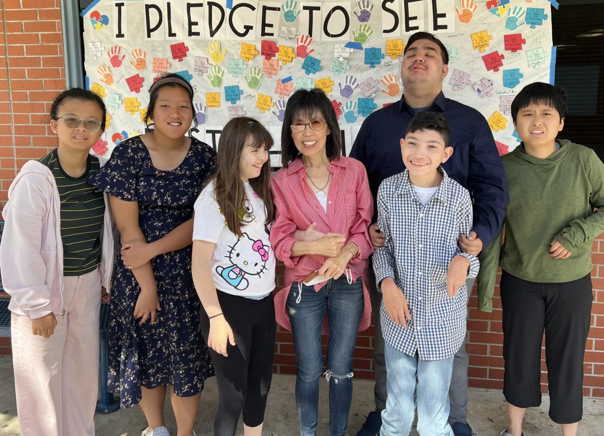 Instructional aide Yanti Wong spends time with her students.