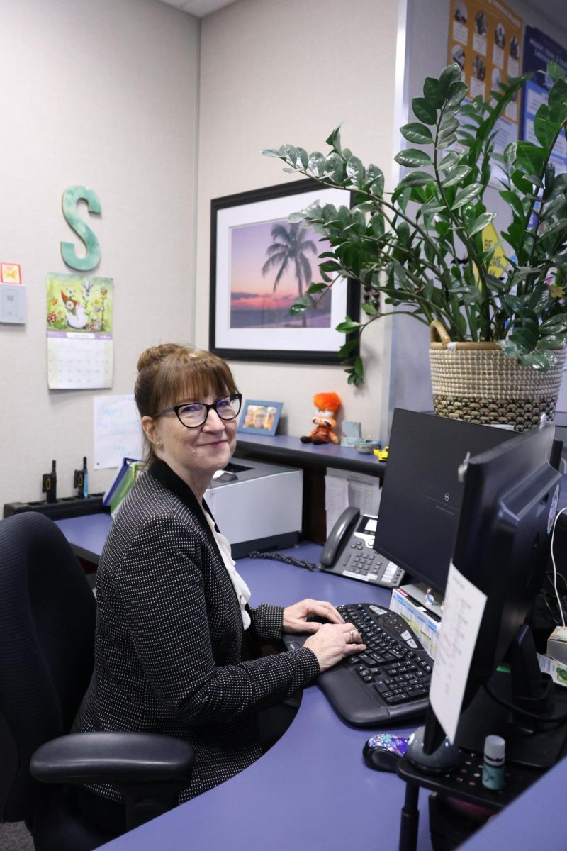 Secretary Shirley Markel works at her desk in the front office, ready to assist students and staff.